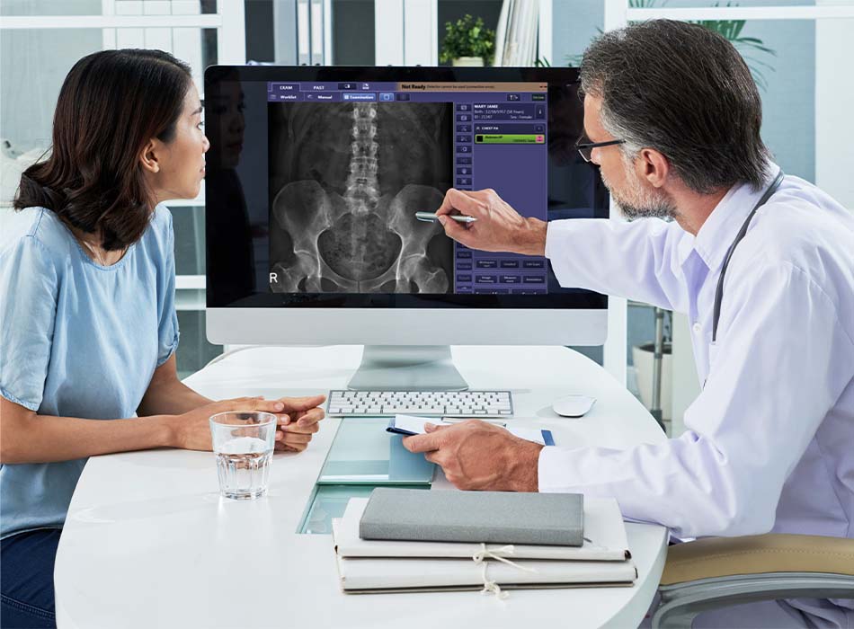 A doctor is explaining an X-ray image to a patient.